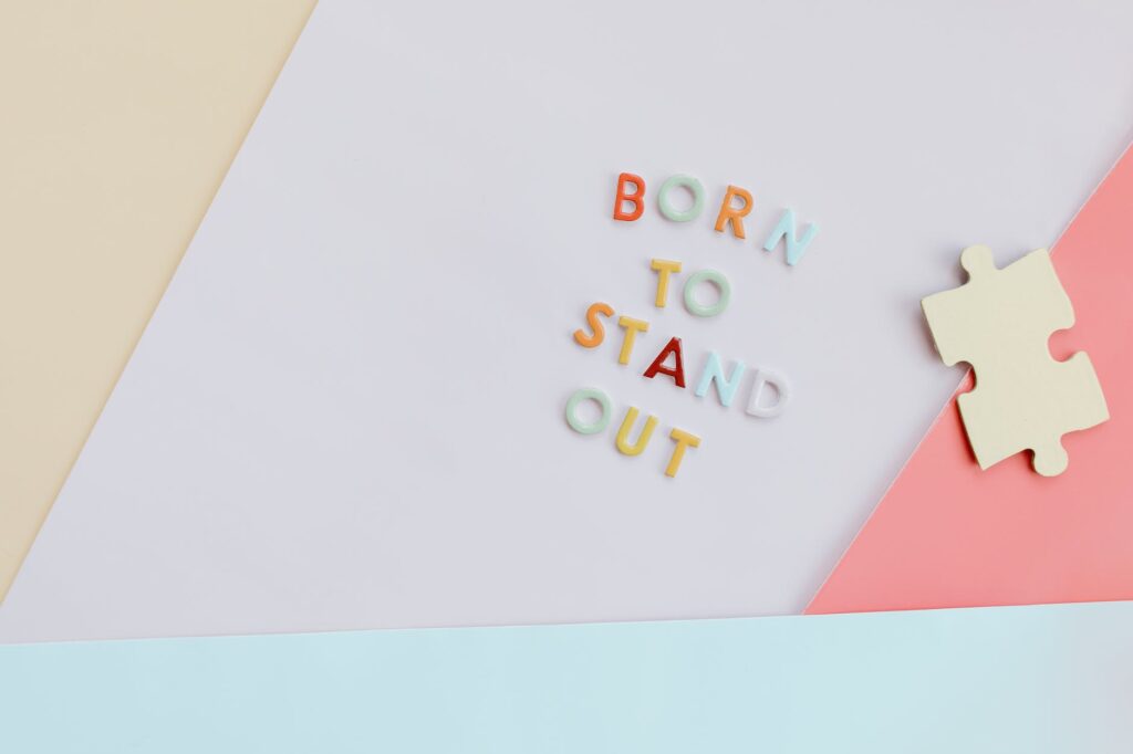 puzzle piece near colorful letters on a surface