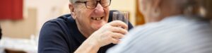 Man laughing with a beer in hand