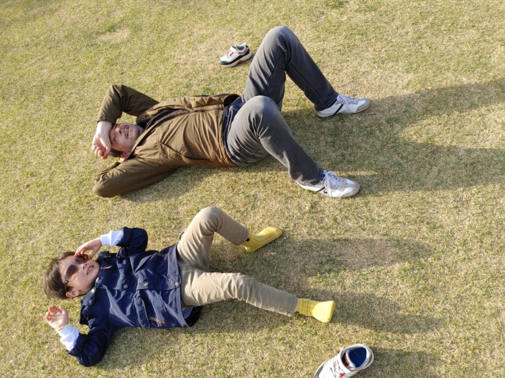 Man and Boy lying in the grass
