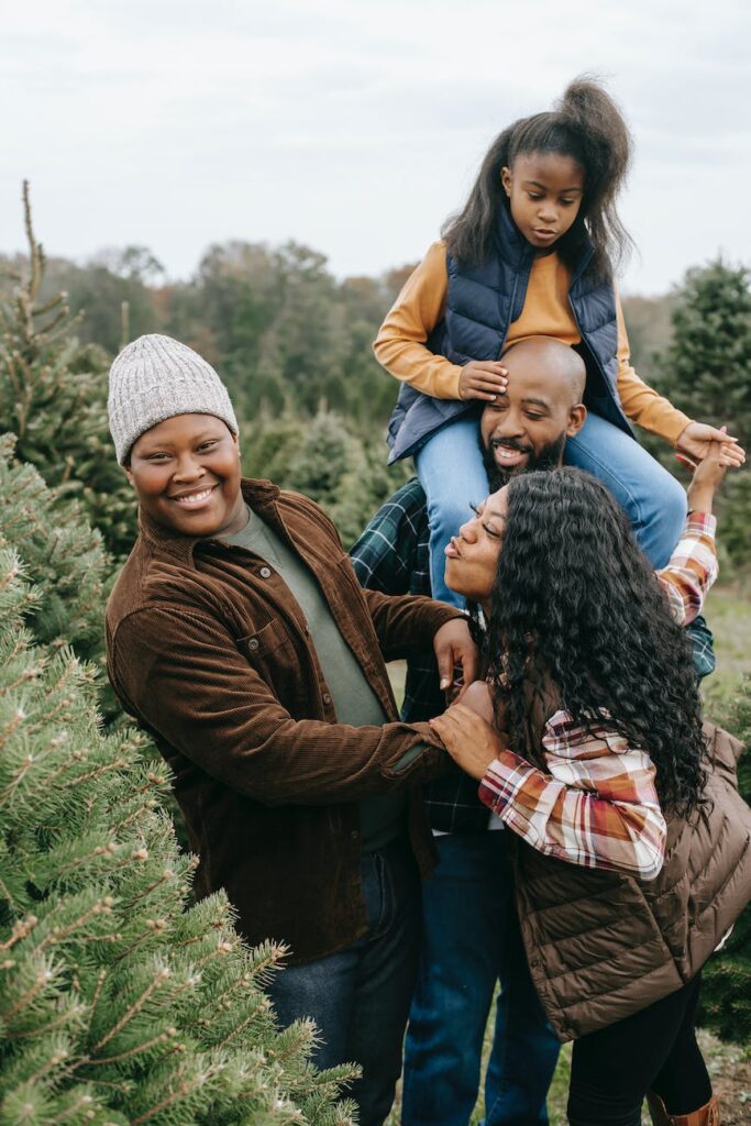 happy black family having fun in fir tree farm