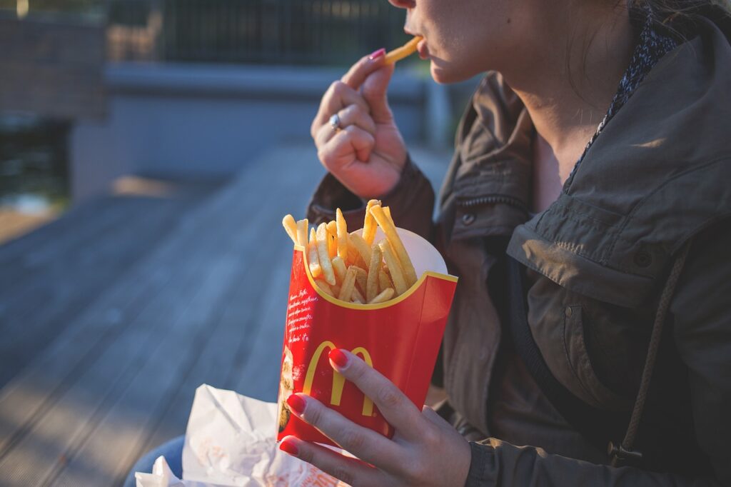 person eating fries