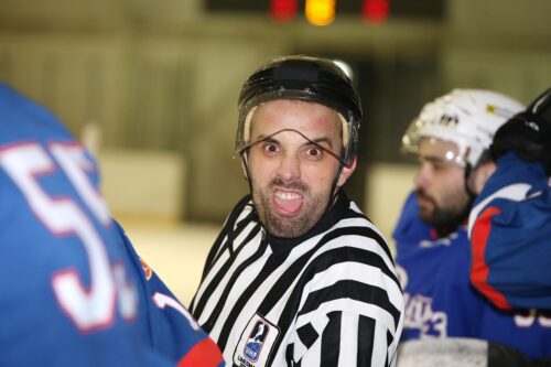 hockey referee making a funny face to the camera