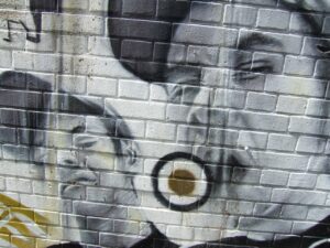 grafitti on the wall with two latino gansgters