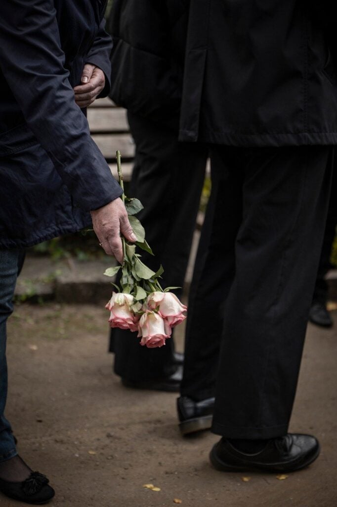 a man's hand giving flowers