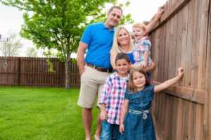 family standing in backyard during summertime