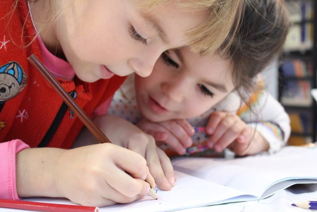 boy and girl writing a note or studying