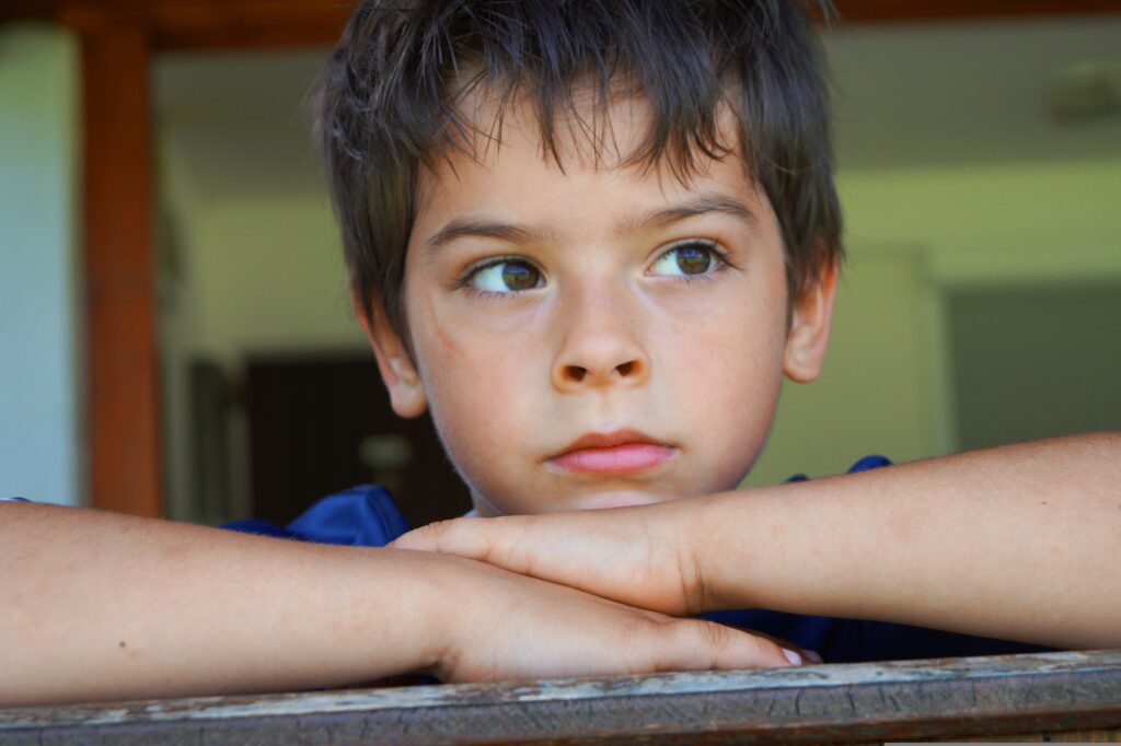 boy looking out the winder(dad blog)